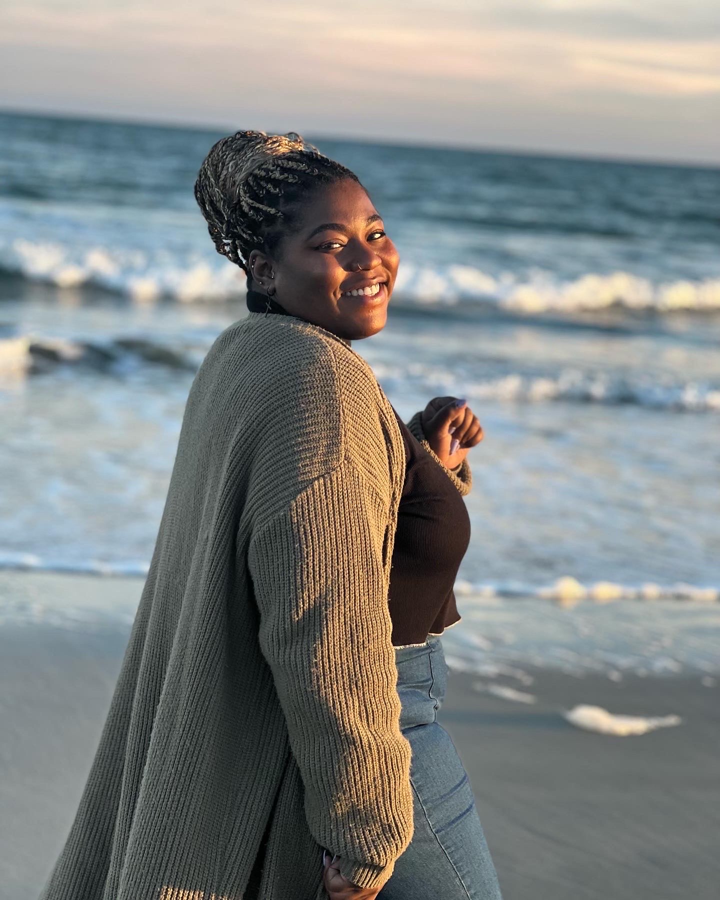 Candace Davis, luxury travel advisor and founder of The Escape Collective, on the beach at golden hour
